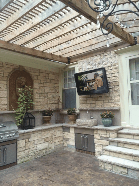 Outdoor kitchen featuring an outdoor TV solution 