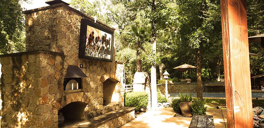  Beautiful stone wall with fire pit and The TV Shield PRO outdoor TV case