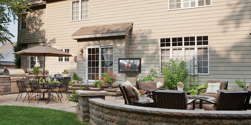 A garden area featuring a fire pit and entertainment area that includes a TV