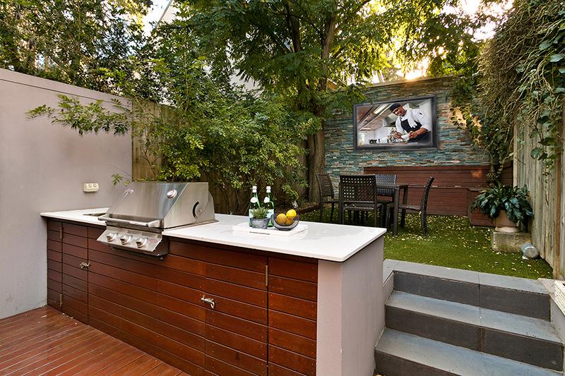 Best use of small backyard space including a kitchen, dining set, and TV
