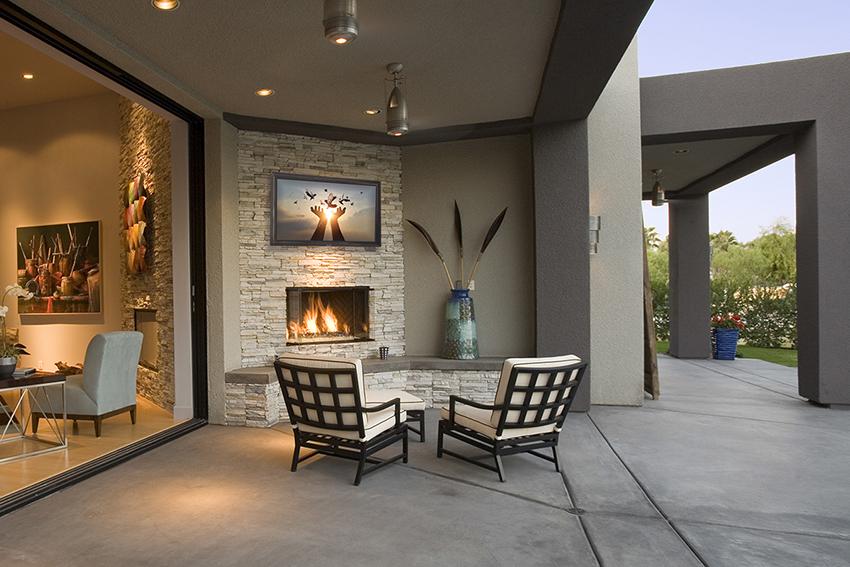 Protected TV directly above the fireplace used outside under cover