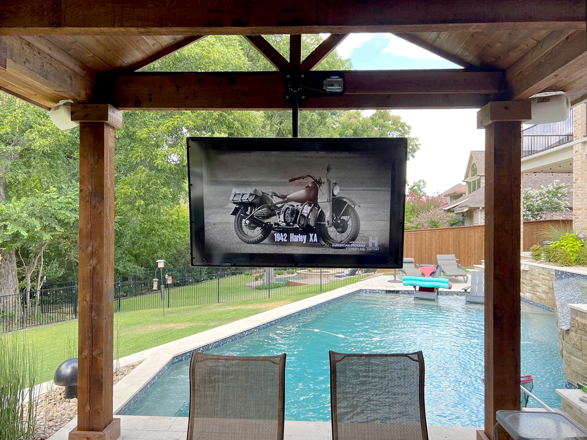 The TV Shield outdoor TV cabinet by a pool